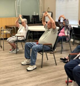 Residents participate in seated exercises